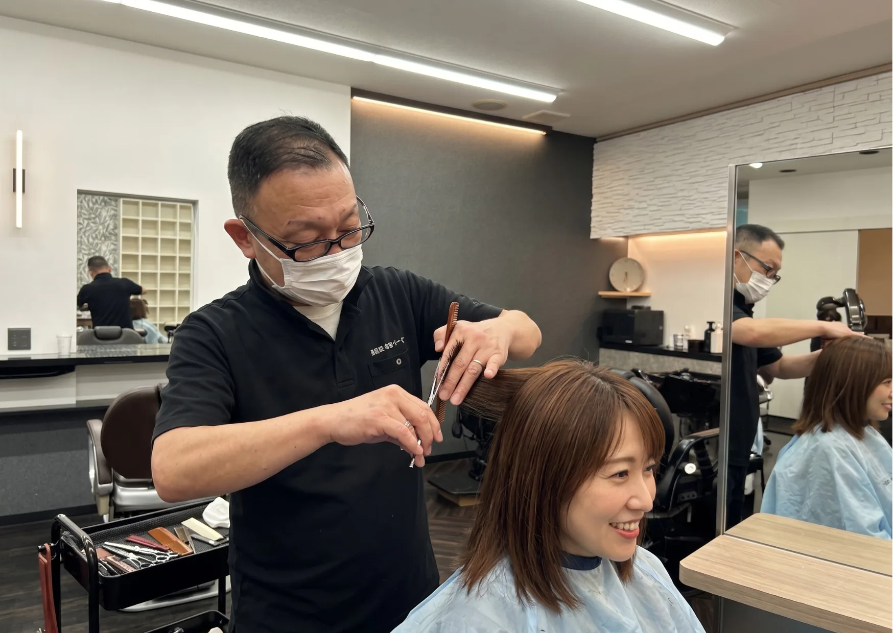 女性のお客様への丁寧なカット施術の様子